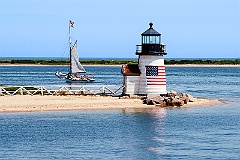 Brant Point Lighthouse Guides a Sailboat out of Nantucket Harbor